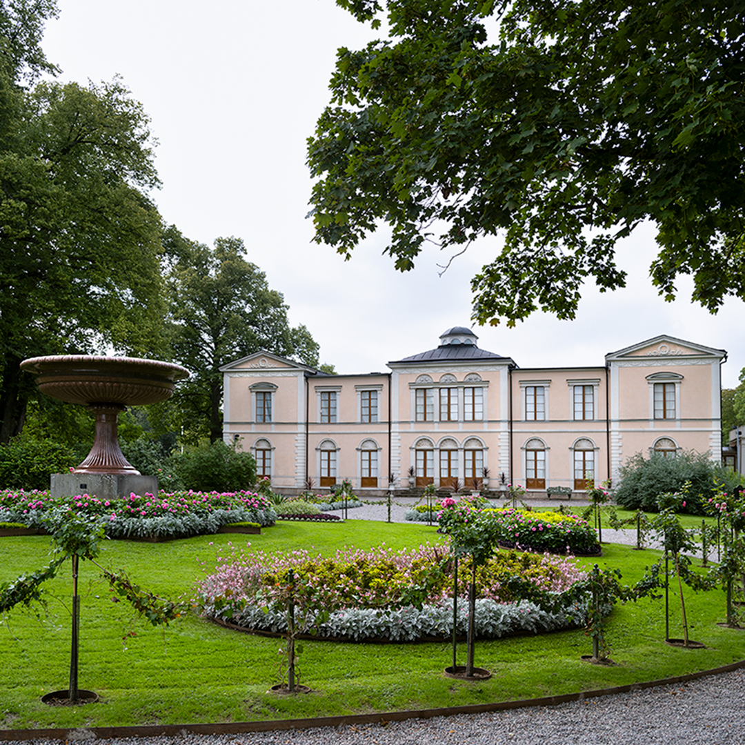 Rosendals slott och den historiska parken som nu återställts. På gräsmattan bland blommorna står den gigantiska porfyrurnan.